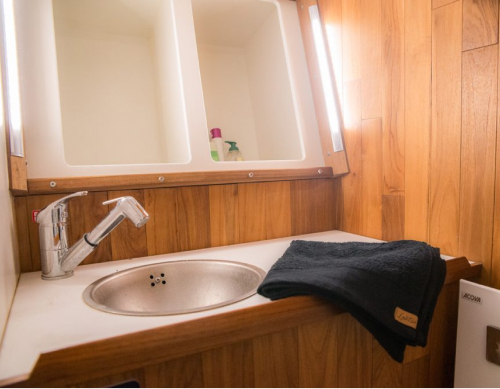 In each cabin, you will have your own bathroom, equipped with a shower, sink, toilet, storage cabinets, mirror, and a towel warmer. You will also find towels and bath sheets there.